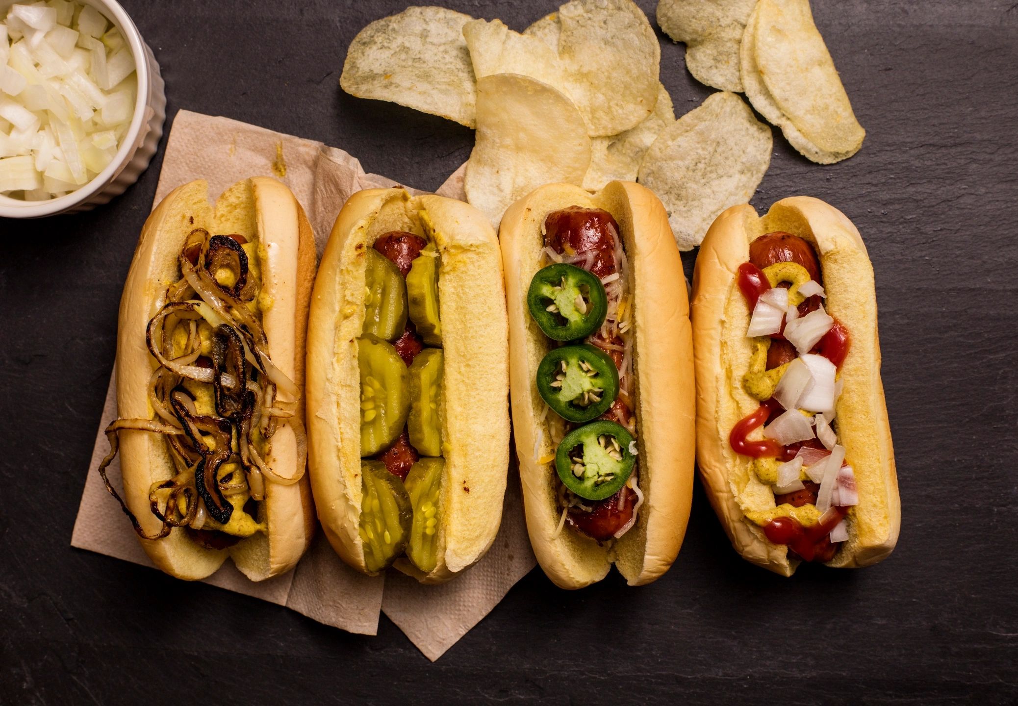 4 gourmet hotdogs with various toppings