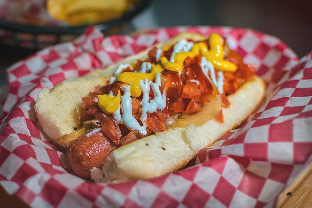 sausage on a hot dog bun with toppings